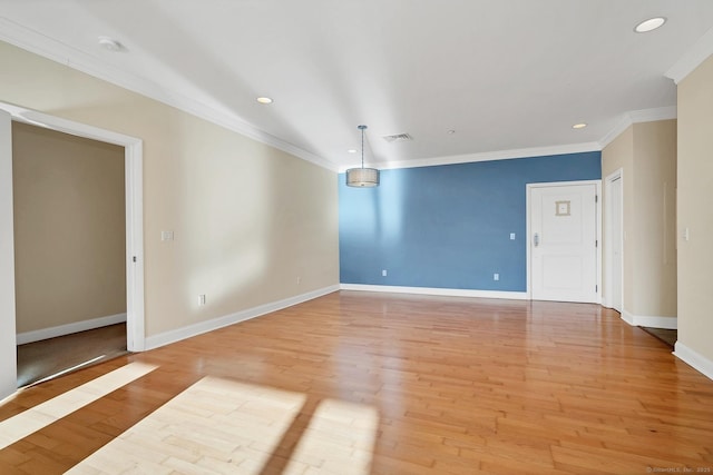 unfurnished room with crown molding and light wood-type flooring