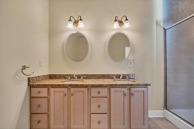 bathroom with vanity and a shower with door