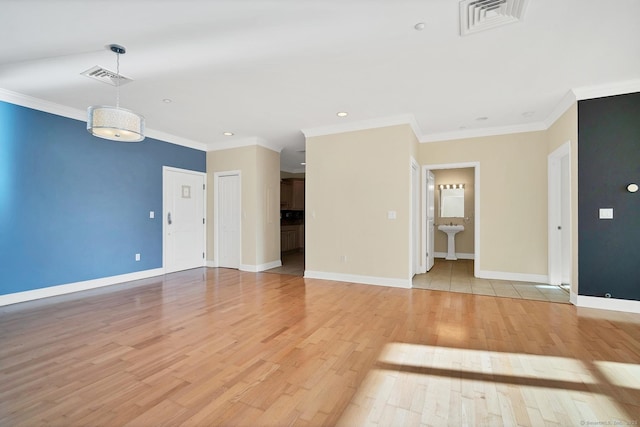 interior space with light hardwood / wood-style floors and ornamental molding