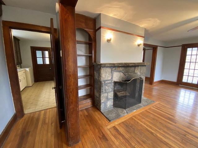 unfurnished living room with a fireplace and light hardwood / wood-style flooring