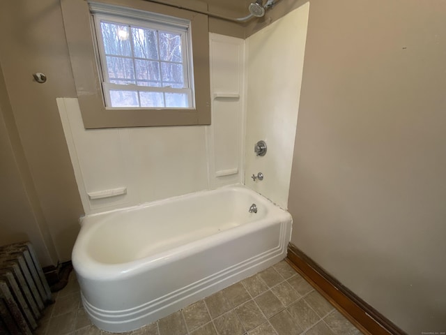 bathroom with radiator heating unit and tub / shower combination