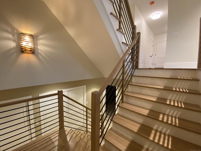 staircase with vaulted ceiling