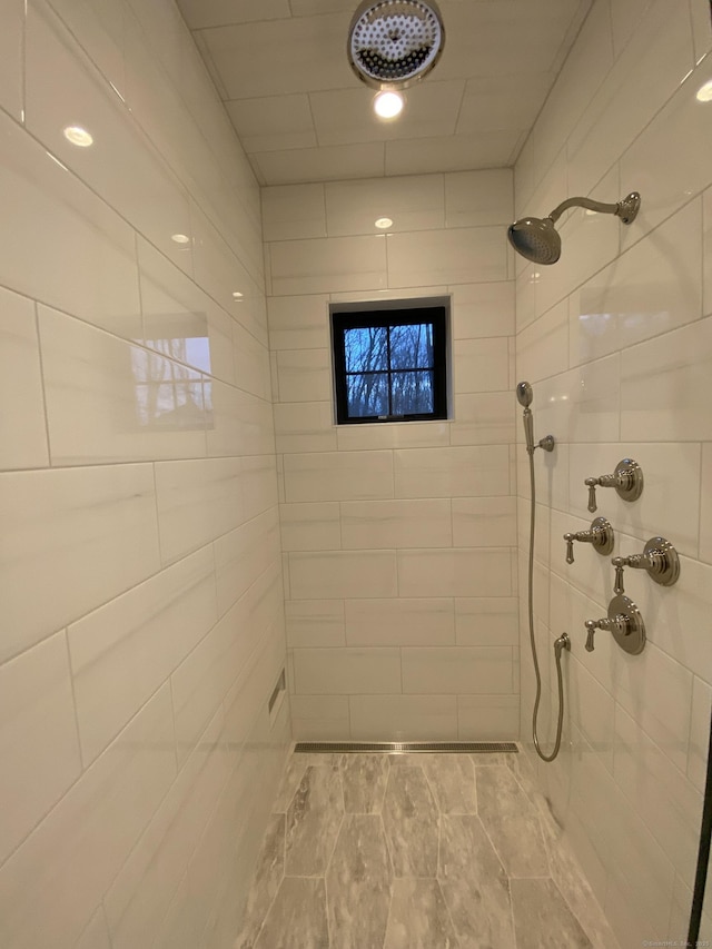 bathroom featuring tiled shower