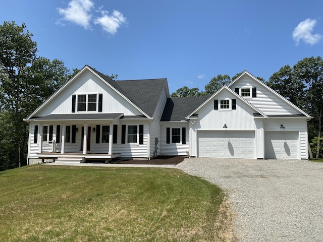 modern farmhouse with a porch, a garage, and a front lawn