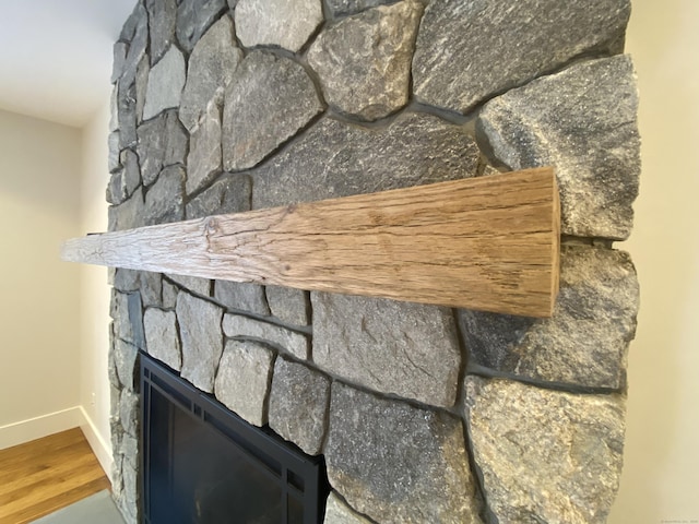 room details with a fireplace and wood-type flooring