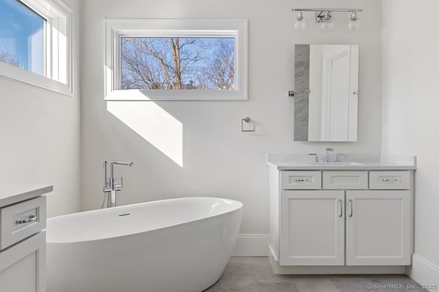 bathroom featuring a tub to relax in and vanity