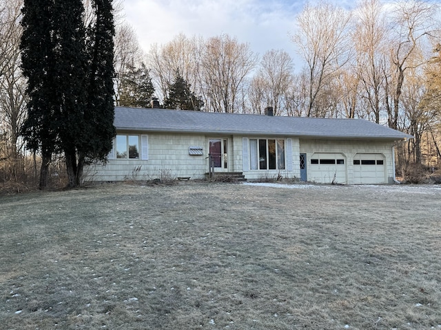 single story home with a front yard and a garage