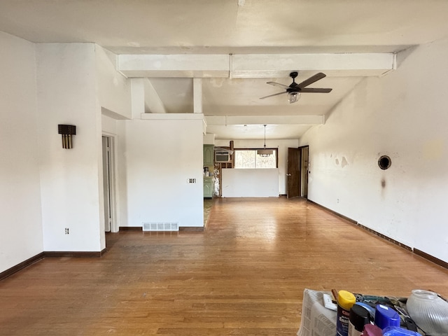 empty room with wood-type flooring, lofted ceiling with beams, and ceiling fan