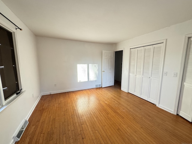 unfurnished bedroom featuring hardwood / wood-style floors