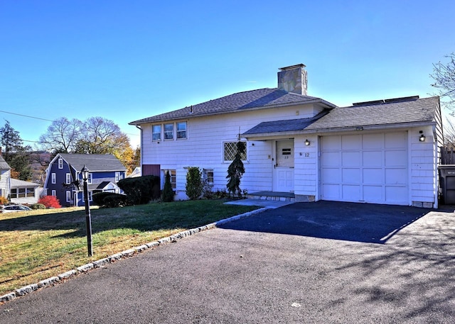 view of front facade with a front lawn and a garage