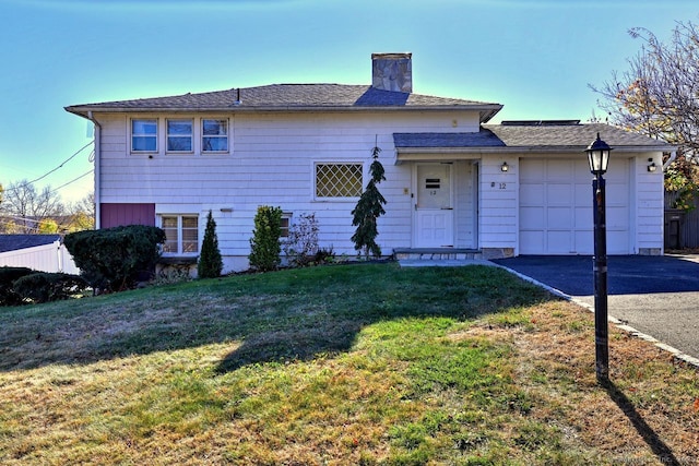 view of front facade with a front lawn and a garage