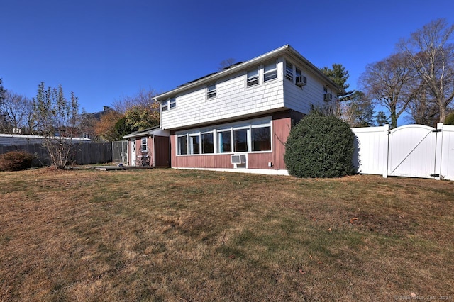 back of house featuring a lawn