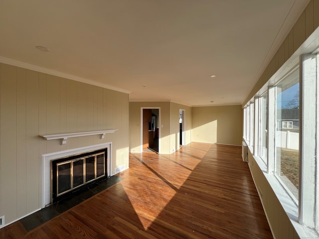 unfurnished living room with dark hardwood / wood-style floors and ornamental molding