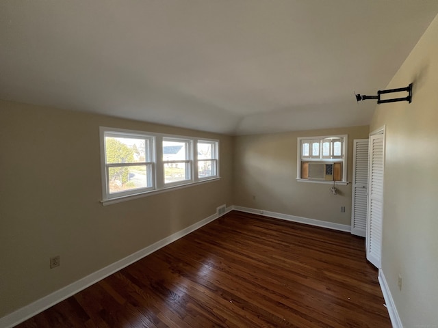 unfurnished room featuring cooling unit and dark wood-type flooring