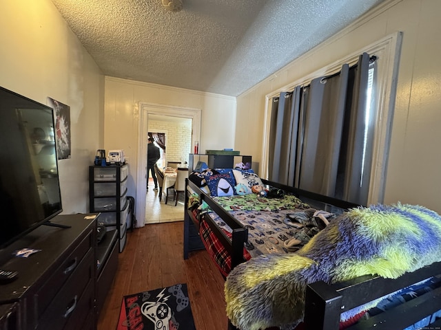 bedroom featuring dark hardwood / wood-style floors and a textured ceiling