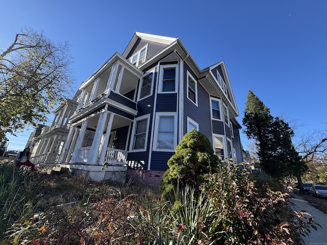 view of property exterior with covered porch