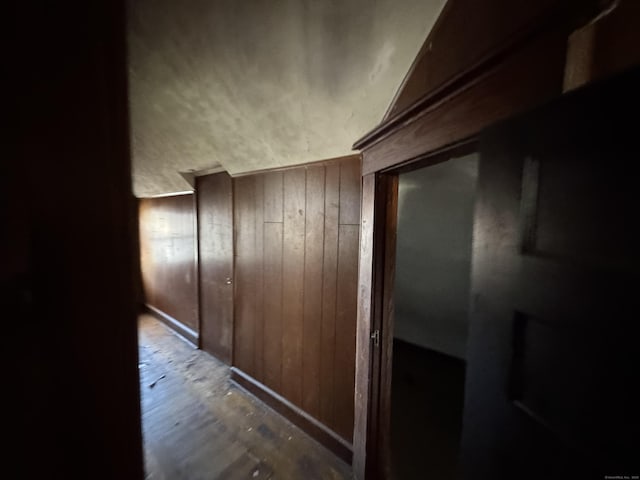 hallway with wood walls