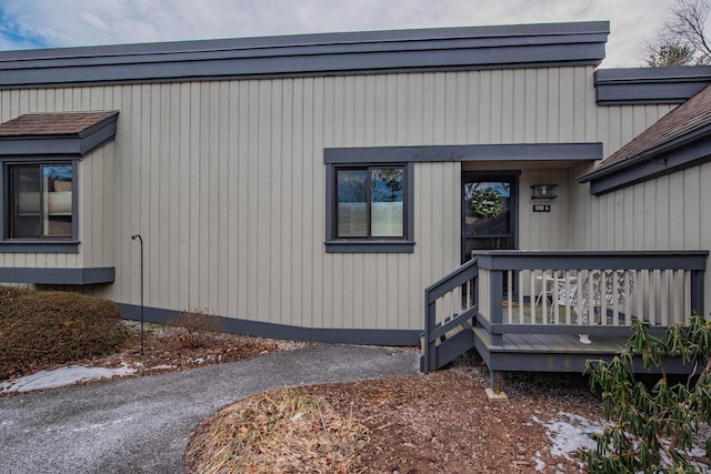 view of exterior entry featuring a wooden deck