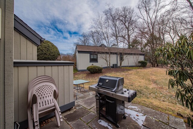 view of patio featuring central AC, an outbuilding, and area for grilling