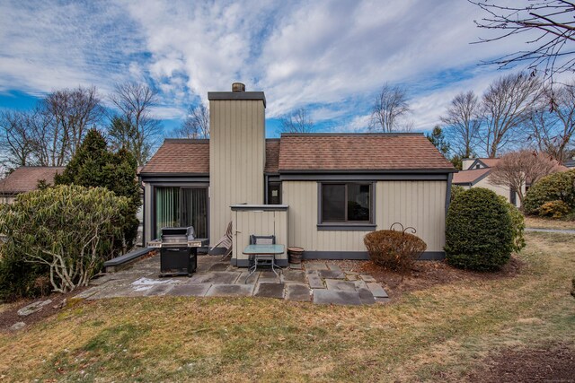 back of property featuring a patio area and a lawn