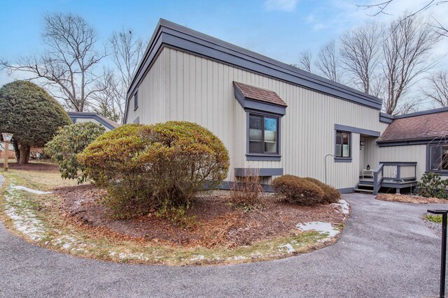 view of property exterior featuring a wooden deck