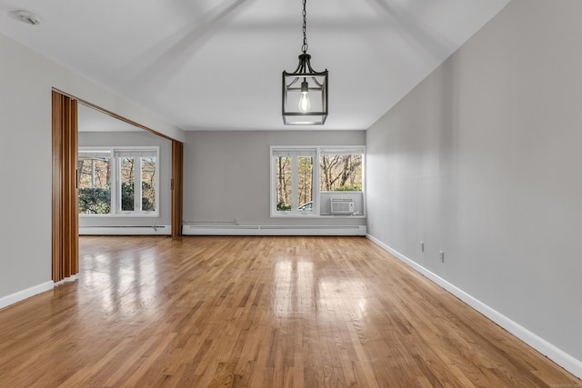 interior space with a baseboard radiator, plenty of natural light, and light wood-type flooring