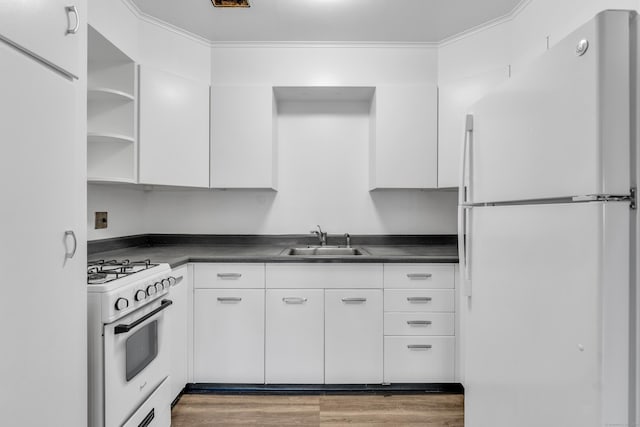 kitchen featuring sink, white appliances, and white cabinets