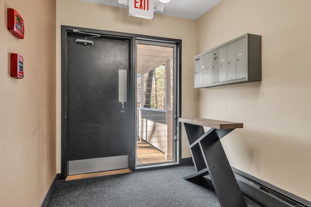 doorway to outside with a mail area and carpet