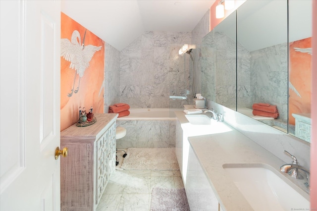 bathroom featuring vanity, tiled bath, and lofted ceiling