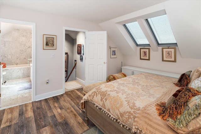 bedroom featuring dark hardwood / wood-style floors, ensuite bathroom, and vaulted ceiling