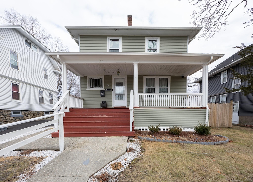 bungalow featuring a front yard and covered porch