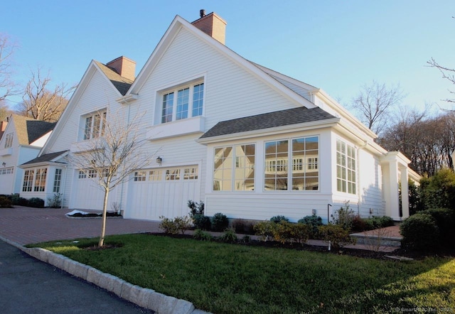 view of home's exterior featuring a garage and a yard