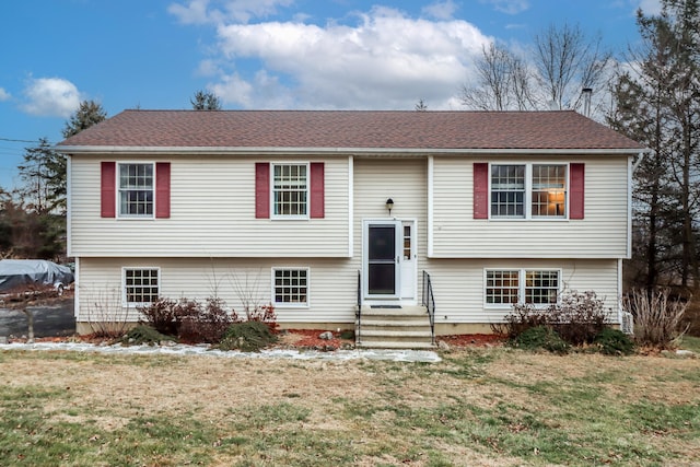 split foyer home with a front lawn