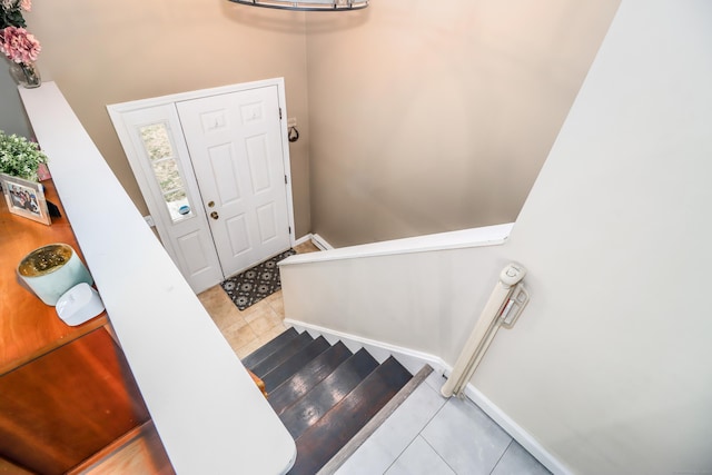 stairway featuring tile patterned flooring