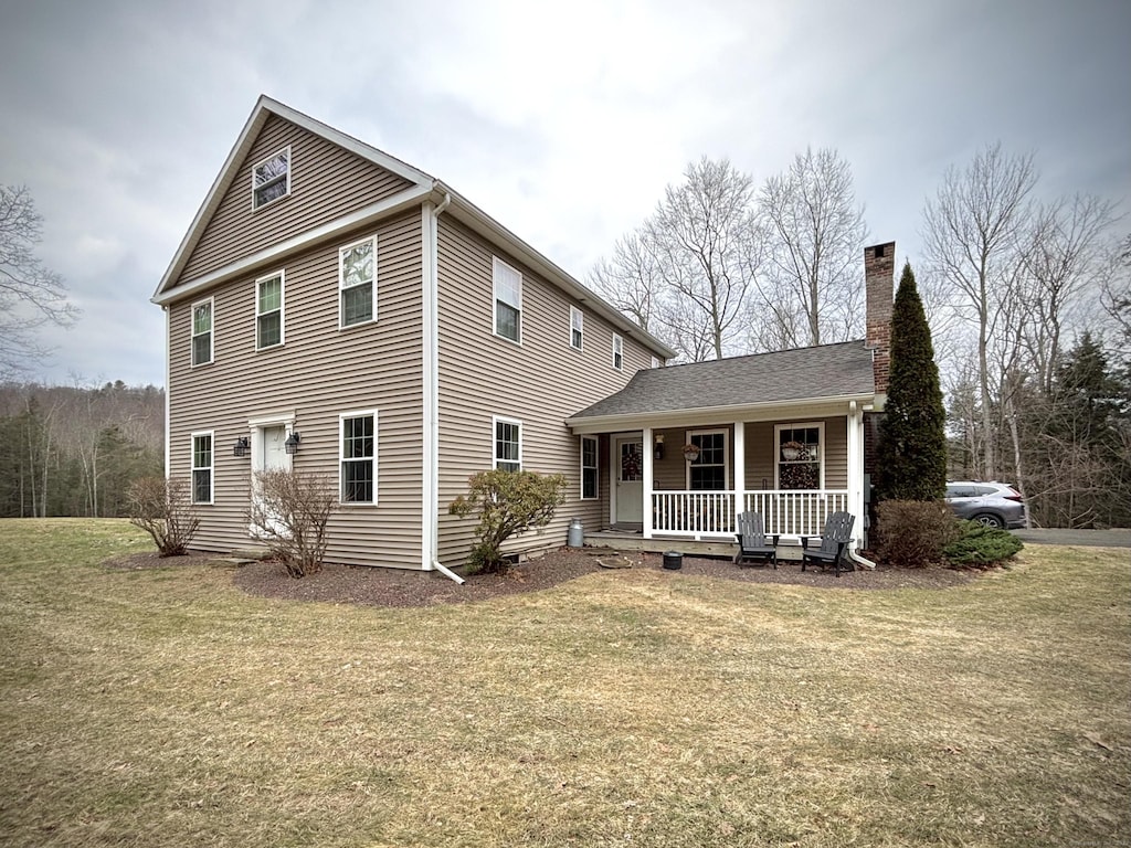 view of front of house with a front yard and covered porch