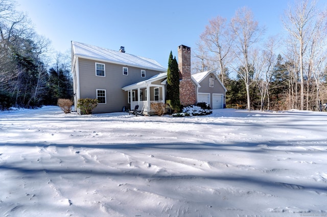 view of snow covered rear of property