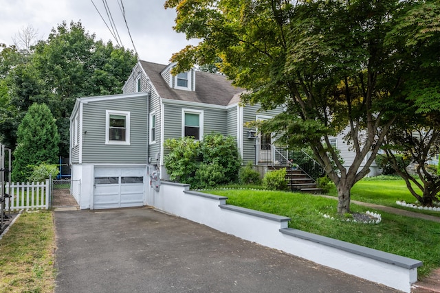 cape cod house with a front lawn and a garage