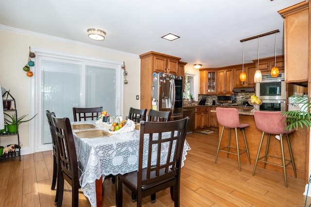 dining area featuring light hardwood / wood-style floors and ornamental molding