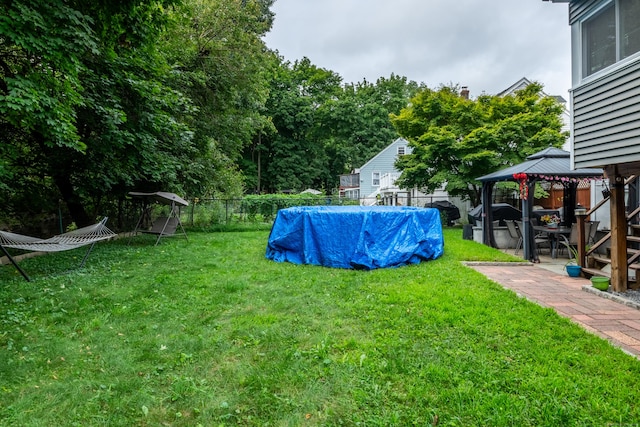 view of yard with a gazebo and a fenced in pool