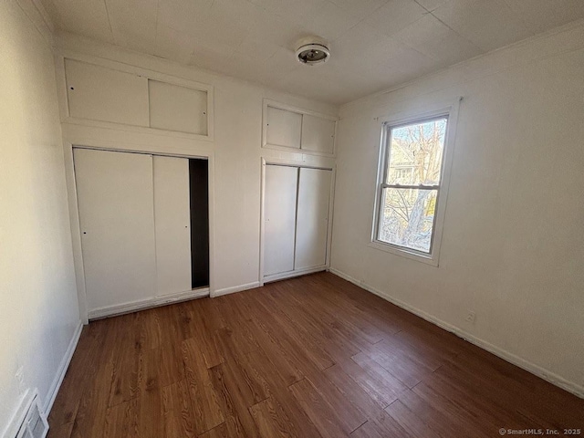 unfurnished bedroom featuring wood-type flooring and a closet