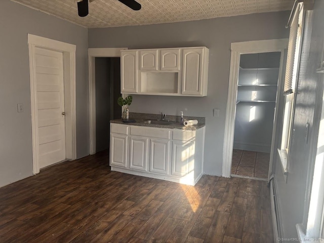 kitchen with ceiling fan, white cabinets, dark wood-type flooring, and sink