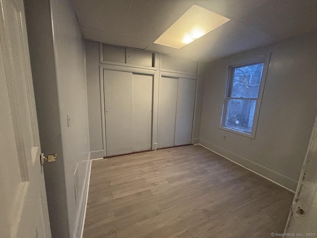 unfurnished bedroom with wood-type flooring