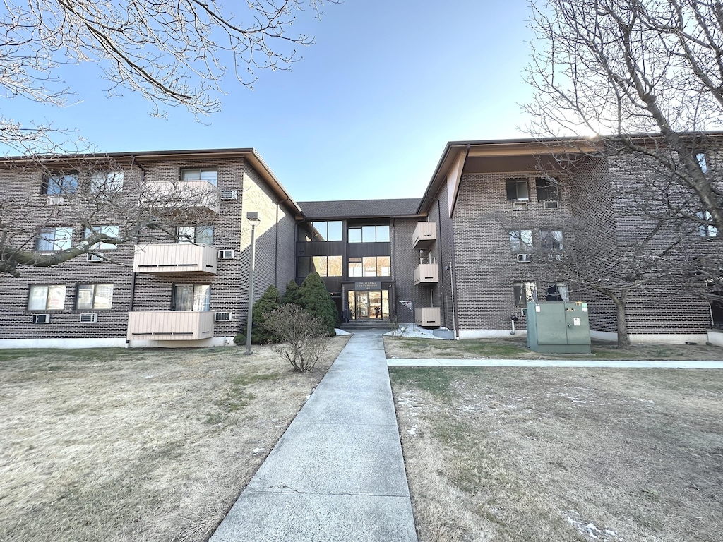 view of building exterior featuring a wall unit AC