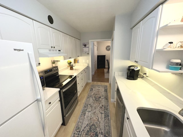 kitchen with white cabinets, stainless steel appliances, light wood-type flooring, and sink