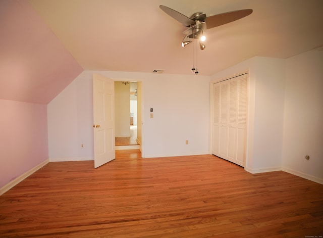 additional living space with ceiling fan, light hardwood / wood-style flooring, and vaulted ceiling