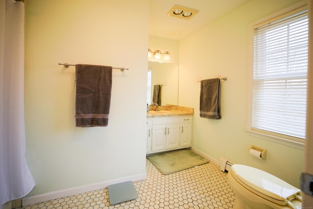 bathroom featuring toilet, vanity, a baseboard radiator, and tile patterned floors