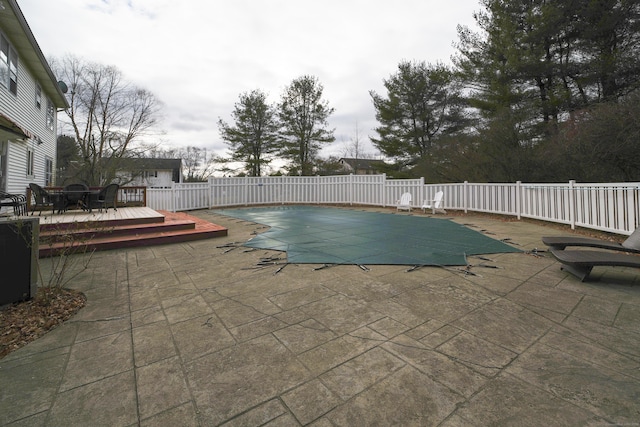 view of pool with a deck and a patio area