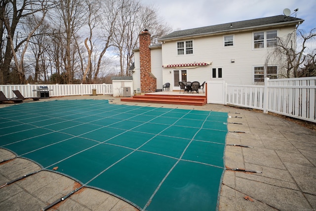 view of swimming pool with a deck and a patio area