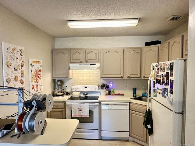 kitchen with sink, white appliances, and a textured ceiling