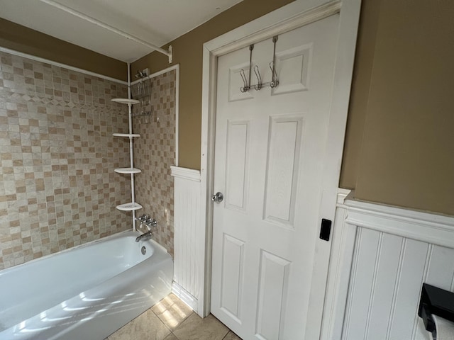 bathroom featuring tile patterned floors and tiled shower / bath